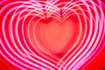 Bright red and pink neon hearts in a full frame abstract overlay background with copy space for a message of love