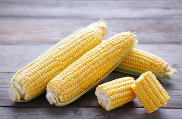 Fresh corn on a grey wooden background