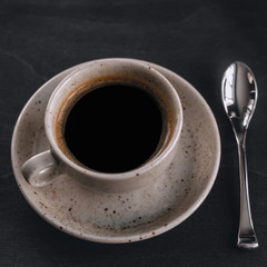 macro photo. light cup of black coffee with chocolate on the rustic table from a height. bokeh