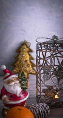 Christmas or New Year composition with a candle, tangerines, and Christmas decorations, pine cones, a place for text. holiday composition of the new year.