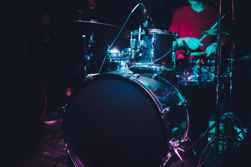 Modern drum set shot in smoky dark studio.