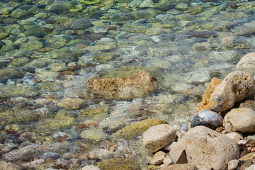 Sea colored stones in the transparent water