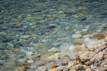 Sea colored stones in the transparent water
