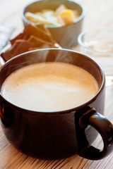 fresh breakfast with hot coffee in morning sunlight