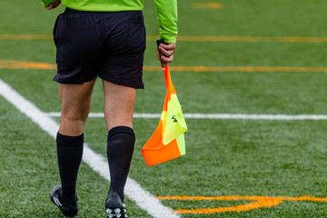 Assistant referee hold flag.