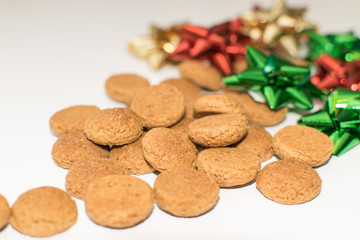 Dutch pepernoten in on a white background with Christmas decoration