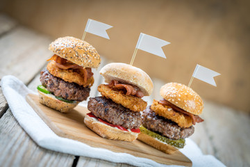 three selection of beef patty mini sliders burger sharing flags onions bacon cool