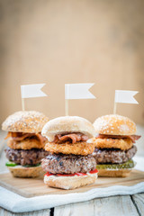 three selection of beef patty mini sliders burger sharing flags onions bacon cool