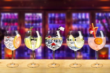 Gin and tonic mixed cocktail drinks various selection garnish bartender bar background fashion...