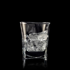 glass for alcohol with pure ice isolated over black background
