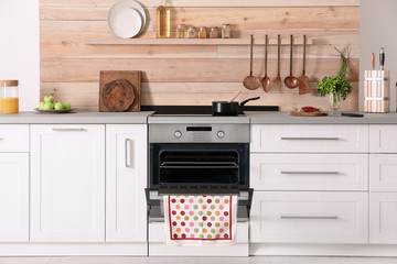 Light modern kitchen interior with new oven