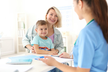 Little boy with mother visiting children's doctor in hospital