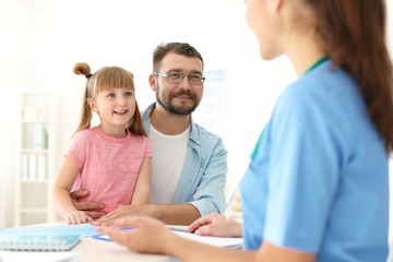 Fototapeta premium Little girl with father visiting children's doctor in hospital
