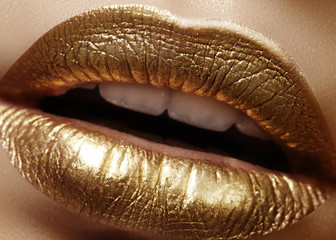 Closeup Female Plump Lips with Gold Color Makeup. Fashion Celebrate Make-up, Glitter Cosmetic. Christmas Style