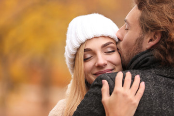 Fototapeta premium Young romantic couple hugging outdoors on autumn day