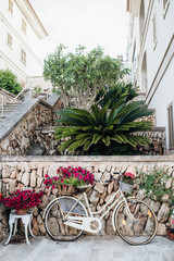 Fototapeta na wymiar Old bicycle with flowers in a Spanish street