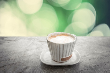 Close up white coffee cup on the table at morning time