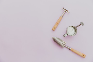 Gardens tools on pastel background flat lay