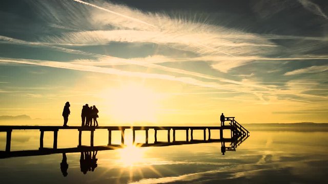 Starnberg Lake nearby Munich Bavaria Germany, people watching sunset, siluete.