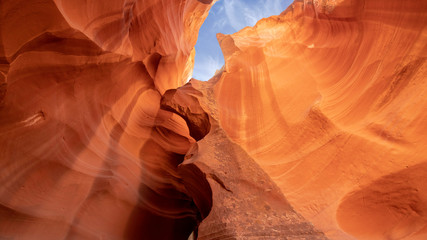 Blue sky with white cloud  above orange yellow color sandstone cliff of Upper antelope