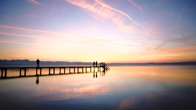 People siluete watch the sunset on the Lake Starnberg in Bavaria, Germany.