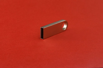 Silver usb flash drive, flash card on red background