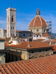 Fototapeta na wymiar The Duomo on the skyline and red rooftops of the city of Florence, Italy