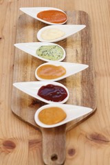 A variety of sauces in a wooden surface