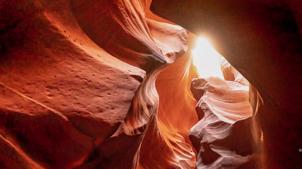 Bright sun seen through a small gap of sandstone ceilling in Upper antelope,