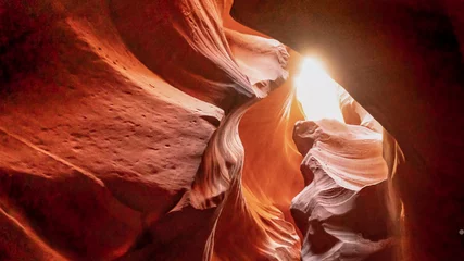 Fototapeten Antilope Bright sun seen through a small gap of sandstone ceilling in Upper antelope,  © LeeSensei