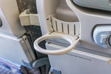 cup holder behind the seat in an plane.