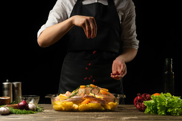 Cooking chef duck sprinkle with grains of pomegranate frozen, horizontal photo, black background
