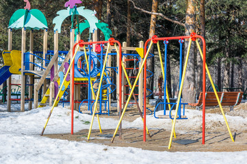 Beautiful swing for skating on playground in spring park.