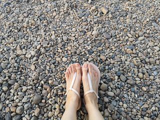 Fashion Beautiful Woman Wearing Nude Sandals on Stone. Female Standing. Hipster Top View Selfie of Legs and Feet on Rock Background