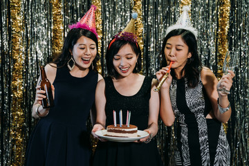 young happy ladies celebrating birthday at club