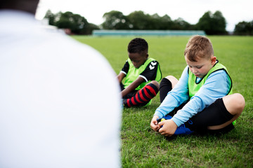 Young football kids stretching on the field