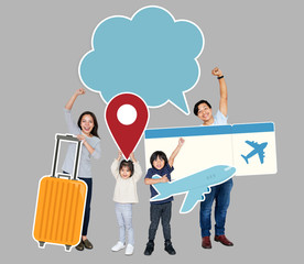 Cheerful family holding travel icons and ticket