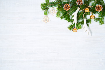 Festive composition of Christmas decorations on white wooden background.