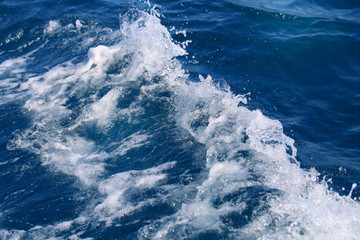 Photo background of blue foaming waves in motion ocean