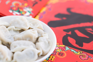 A dish of dumplings under the background of red couplets during the Spring Festival