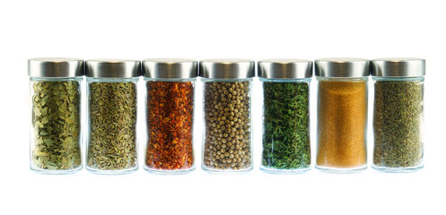 collection of spice and herbs seasoning in glasses bottles isolated on white background