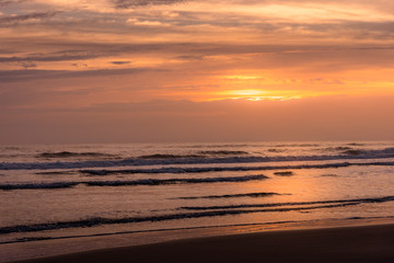 Naklejka na ściany i meble Beach shot with waves during sunrise in Saint Augustine Beach