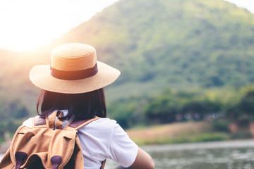 Female tourists in beautiful nature in tranquil scene of rivers and mountains.