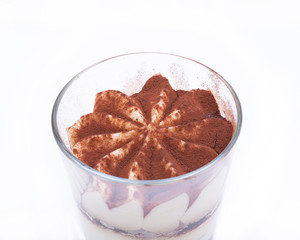 Sweet Italian dessert tiramasu with delicate mascarpone cream from traditional recipe in glass isolated on white background