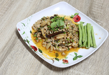 Spicy minced pork salad thai tradition food on wooden background with copy space