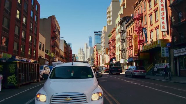 NEW YORK CITY, USA - OCT 30, 2018: Cross walk street with skyscrapers in Chinatown in downtown Manhattan. 