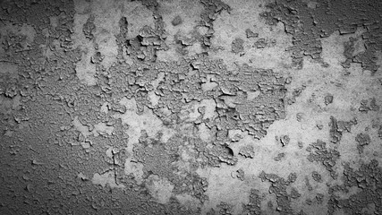 grey peeling paint on the old rough concrete surface . black and white view with vignette
