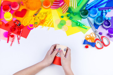 Children's hand making paper crafts