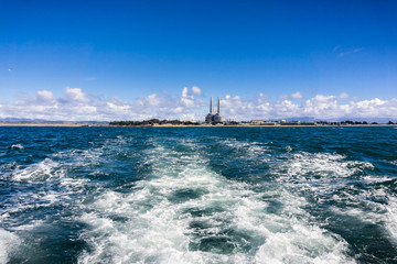 Leaving the coastline on a high speed boat; the Moss Landing coastline with the power plant...