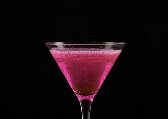 pink cocktail in a glass on a dark background